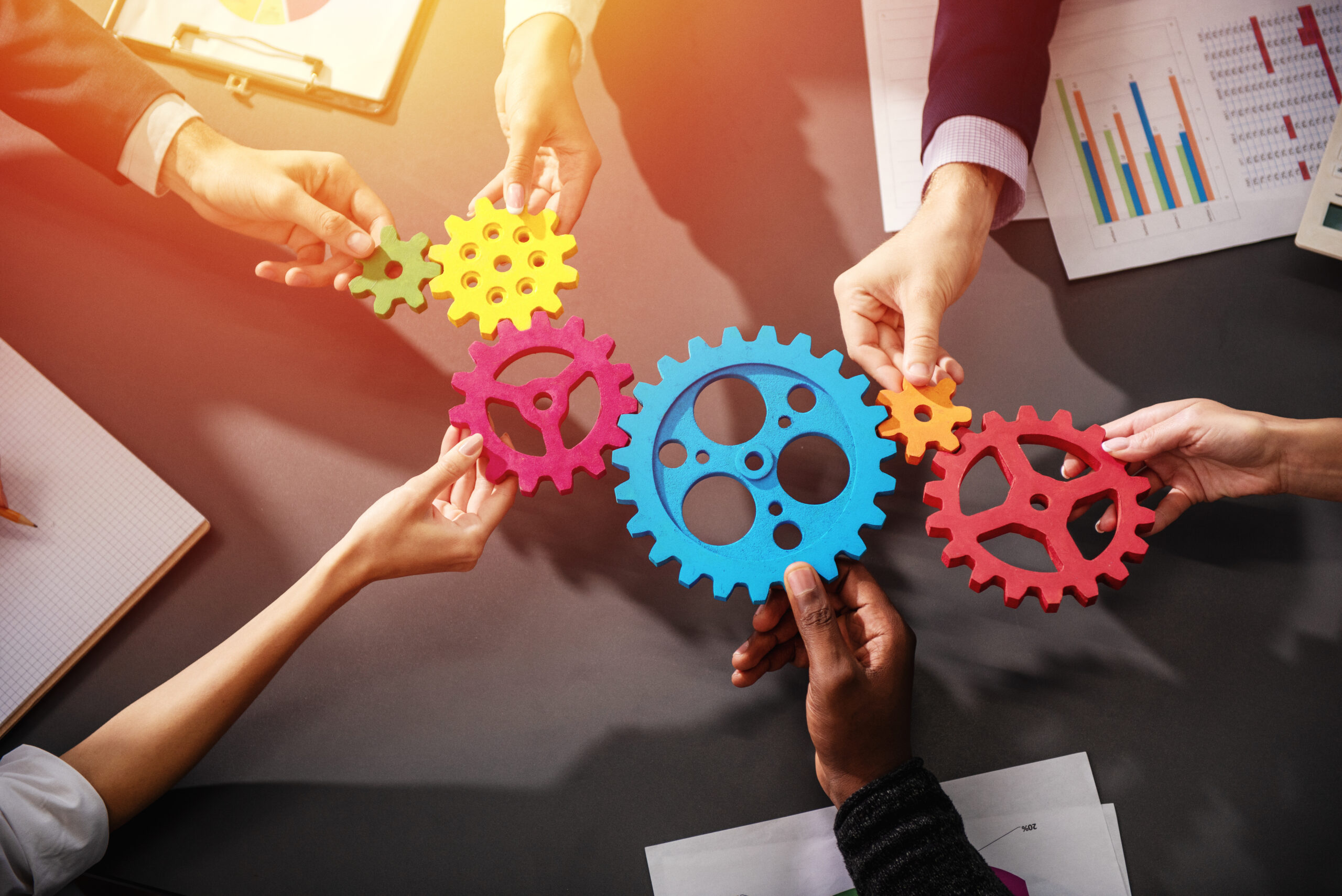 Business team connect pieces of gears. Teamwork, partnership and integration concept